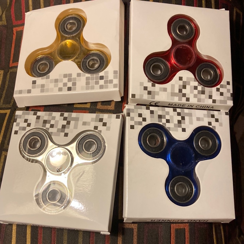 Set of Four Fidget Spinners - Red, Blue, Yellow, Clear